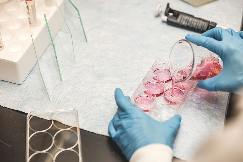 scientist-pouring-red-liquid.jpg